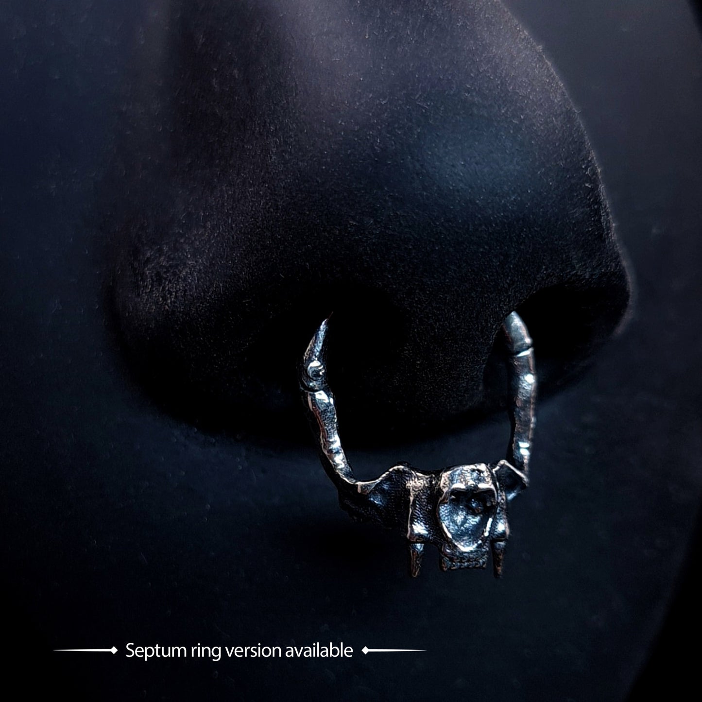 RBZ Jewelry Sterling silver Gothic Cat Skull Jawbone clicker septum ring featuring anatomical feline fangs, shown worn on a black nose model with the text "Septum ring version available."