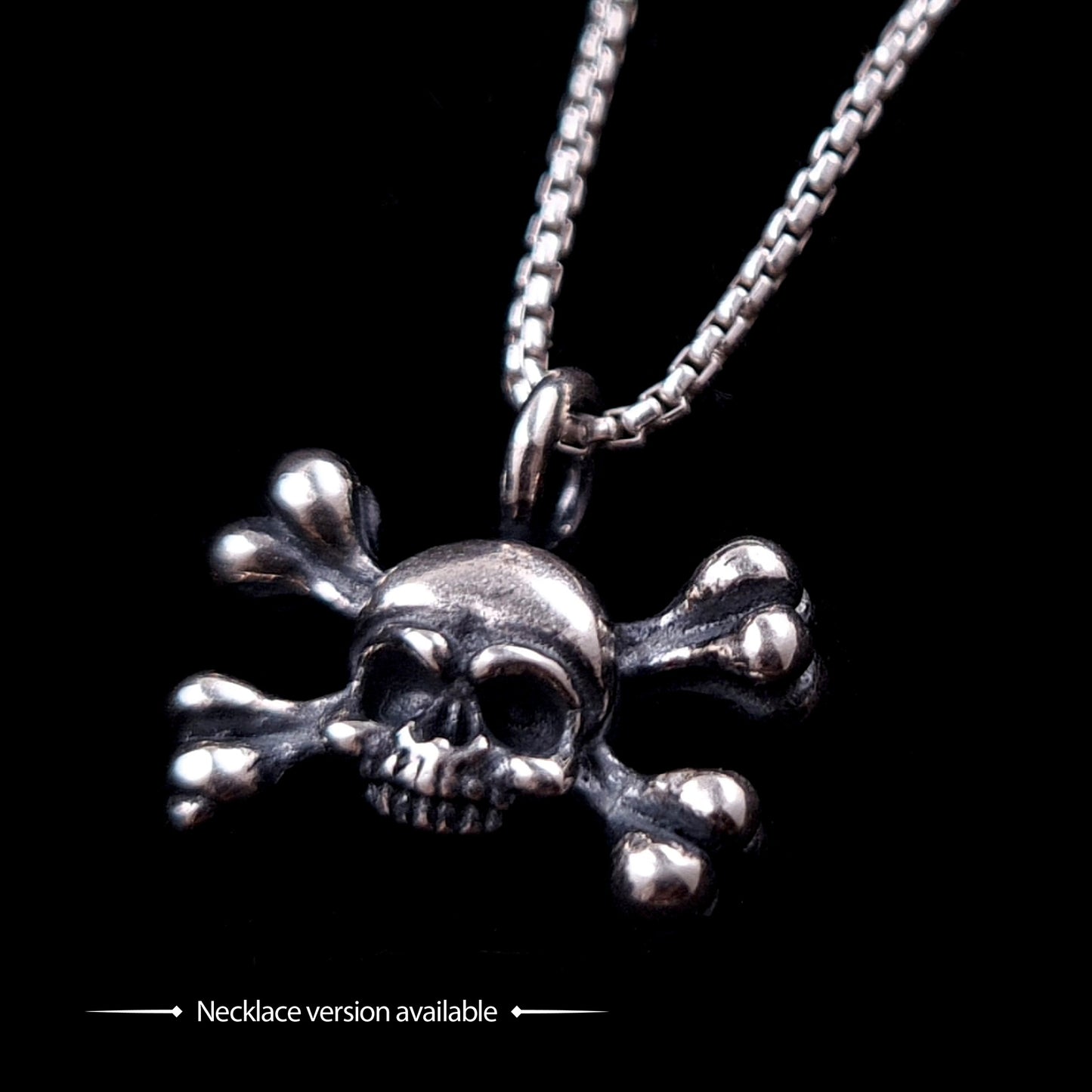 Hand-crafted sterling silver skull and crossbones pendant necklace by RBZ Jewelry, featuring a weathered, oxidized finish and detailed gothic memento mori design on a box chain against a solid black background.