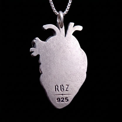 The back view of the sterling silver anatomical heart pendant by RBZ Jewelry, featuring a smooth matte finish with the "RBZ" brand logo and "925" silver hallmark engravings against a black background.
