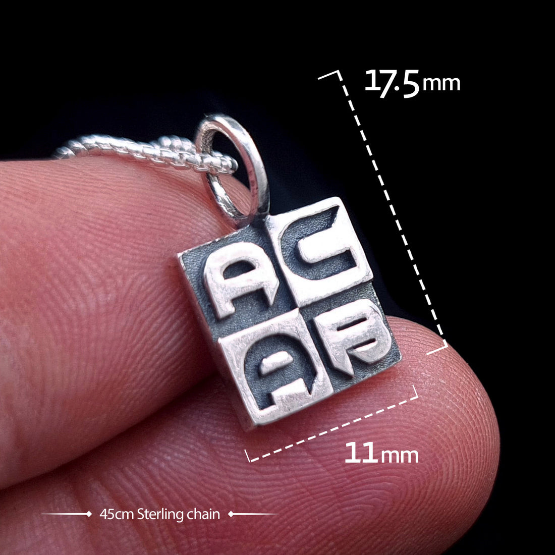 Front view of the sterling silver ACAB pendant held in hand for scale, featuring dimension overlays of 11mm width and 17.5mm height, shown with a 45cm sterling silver chain.