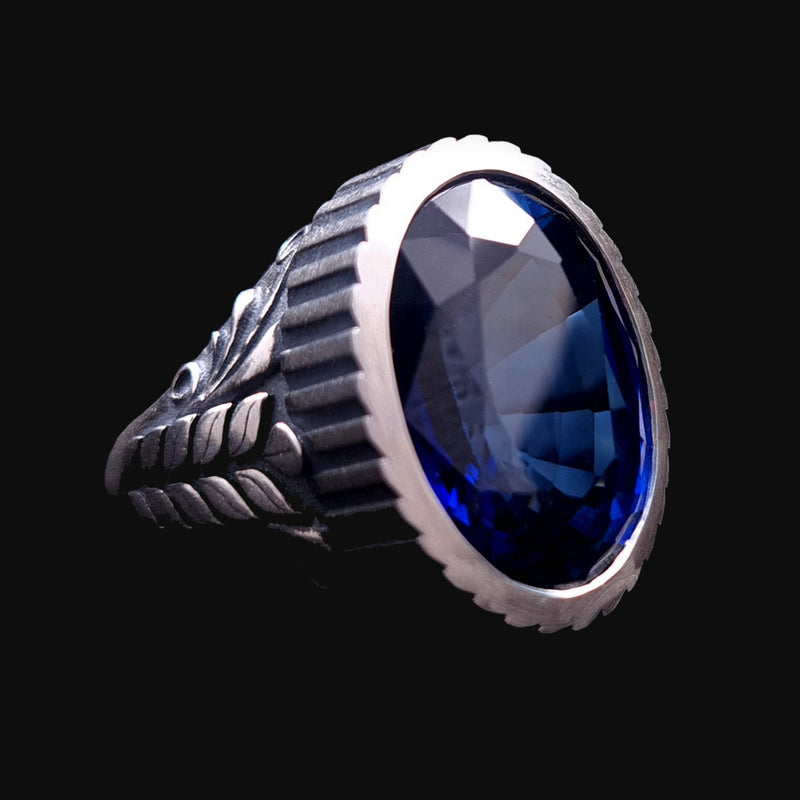 Custom-made men's Sapphire signet ring, featuring a massive gemstone, a bold corrugated bezel, and a wheat pattern, crafted from Sterling silver by RBZ Jewelry.
