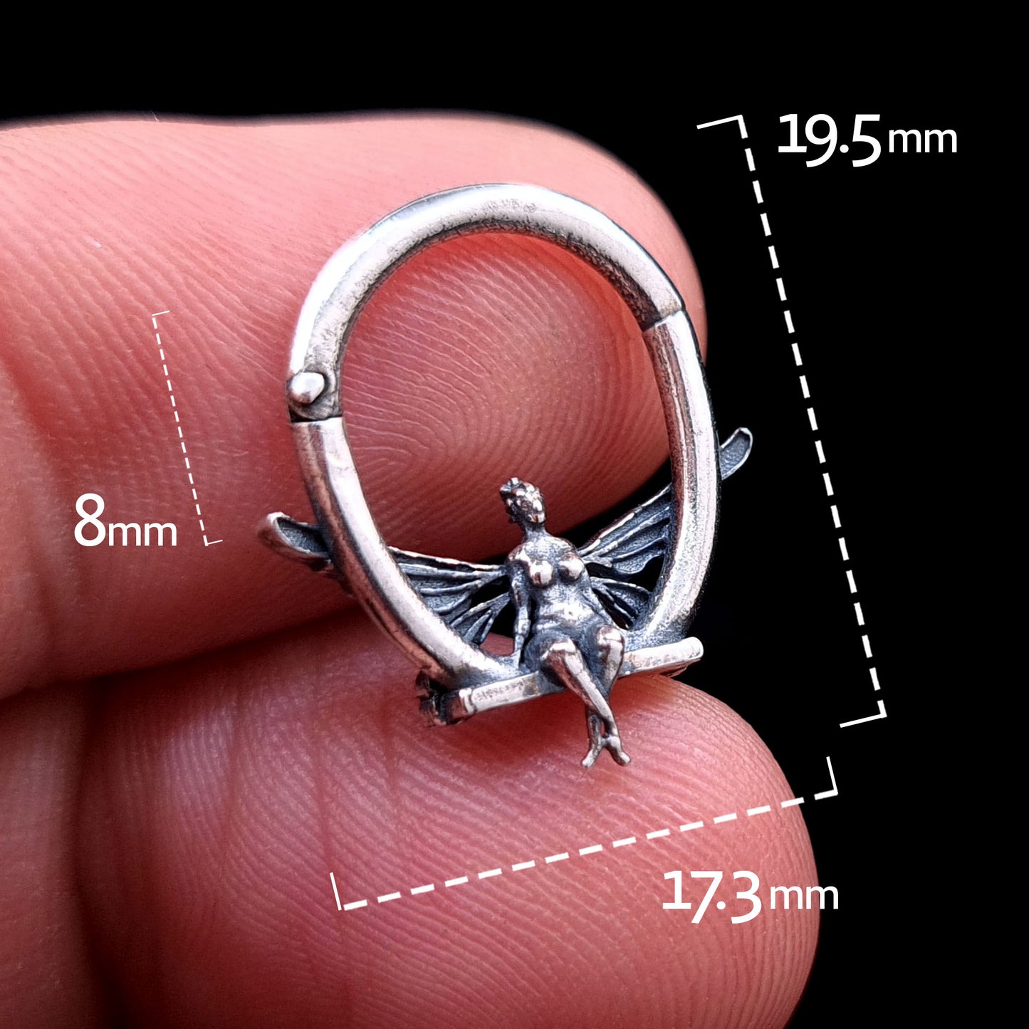 Solid 925 sterling silver fairy septum clicker shown from the front with dimension markings: 19.5mm total height, 17.3mm total width, and 8mm internal hoop space. Held between fingers to show scale.