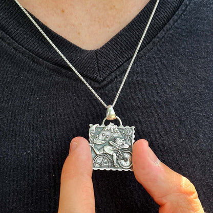 Artistic display of the sterling silver Albert Hofmann blotter pendant by RBZ Jewelry