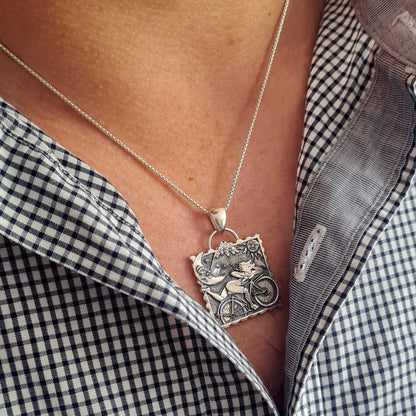 Lifestyle photo of the Dr. Albert Hofmann pendant worn on a chain, showing its appearance on a person