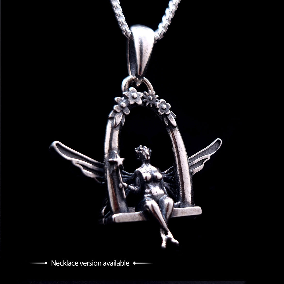 Solid 925 sterling silver fairy pendant featuring a detailed fairy sitting on a swing under a floral arch, shown on a silver chain as the necklace version of the design, by RBZ Jewelry.