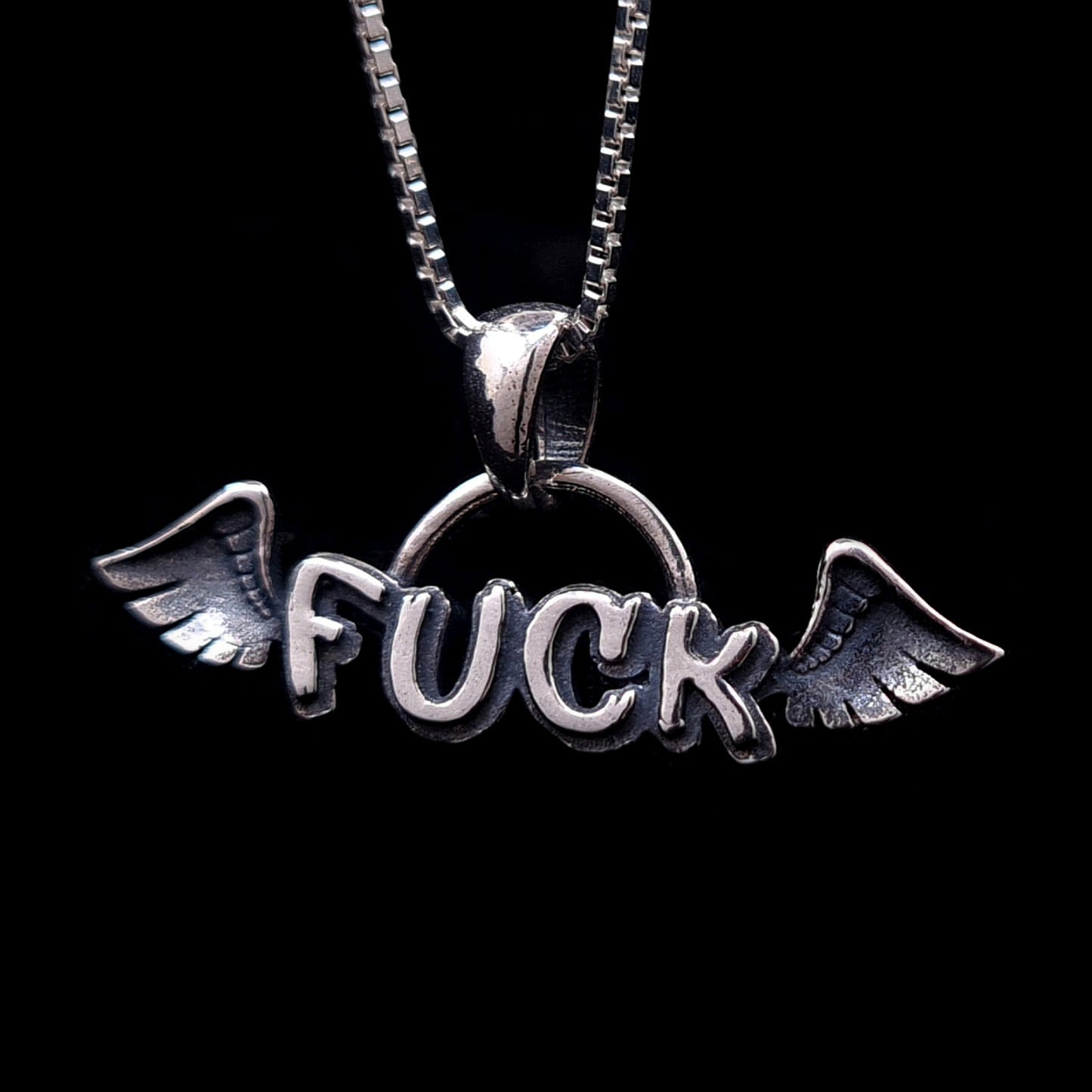 Sterling silver Flying Fuck pendant by RBZ Jewelry, featuring a winged "FUCK" design on a silver box chain.