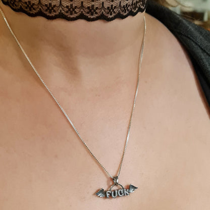 Female model wearing the sterling silver Flying Fuck pendant by RBZ Jewelry on a silver chain, styled with a black lace choker to showcase the gothic, alternative aesthetic.