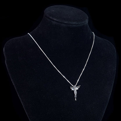 Sterling silver Bat Jesus pendant by RBZ Jewelry displayed on a black velvet mannequin bust, showing the gothic crucifix with bat wings on a fine silver chain to illustrate how the piece sits when worn.