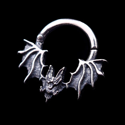 RBZ Jewelry Gothic Sterling Silver Glitched Bat septum clicker ring featuring a studio-crafted distorted bat silhouette with textured spread wings, isolated against a solid black background.