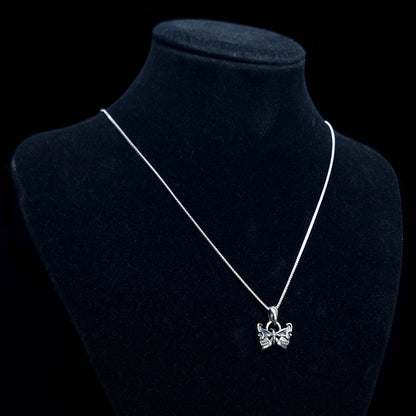 RBZ Jewelry Sterling silver Gothic Butterfly Skull pendant on a long silver chain, displayed on a black velvet mannequin bust against a black background to show scale and wear.