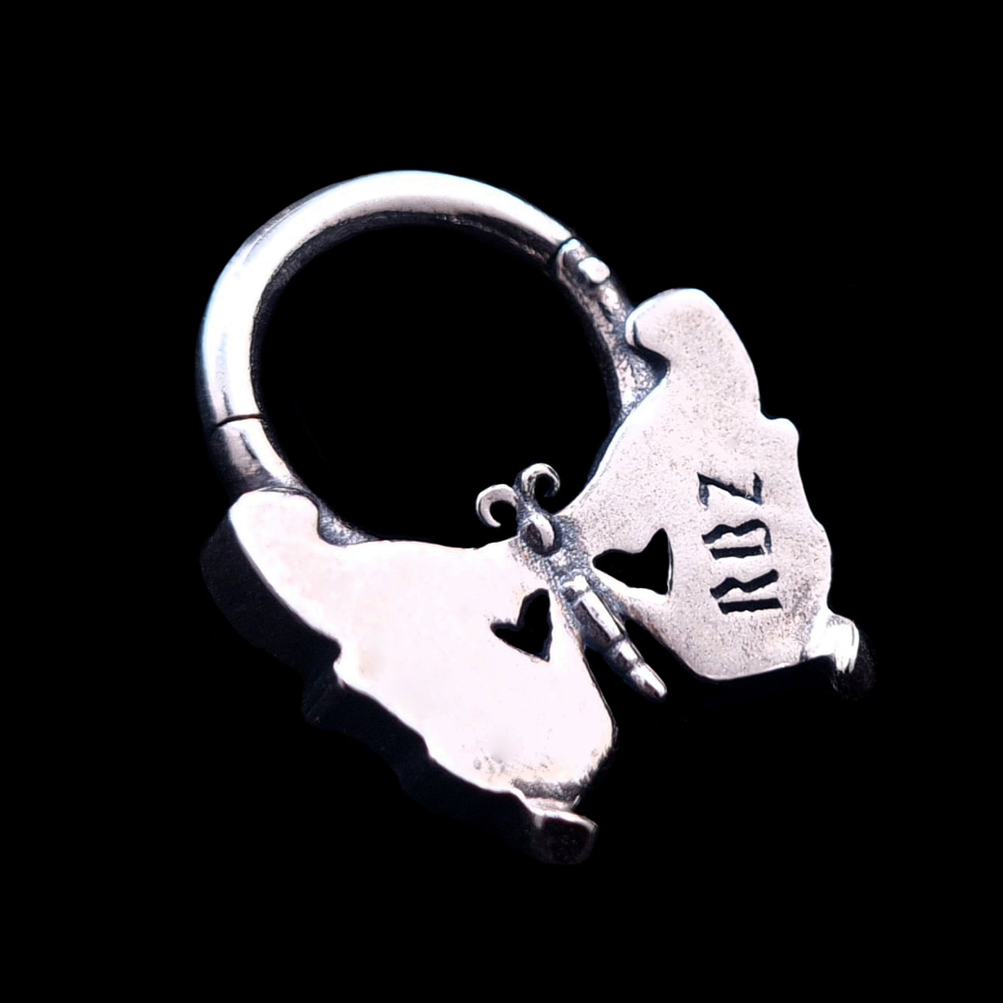 Back view of the Sterling silver butterfly skull septum clicker ring by RBZ Jewelry, showing the smooth reverse side of the wings with an RBZ logo engraving.
