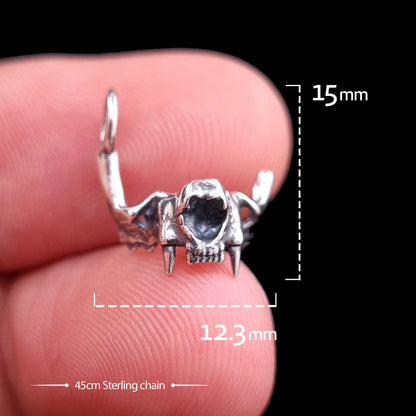 Front view of the RBZ Jewelry Sterling silver Gothic Cat Skull Jawbone pendant held on a finger for scale, featuring text overlays for dimensions (15mm height, 12.3mm width) and a 45cm Sterling chain.