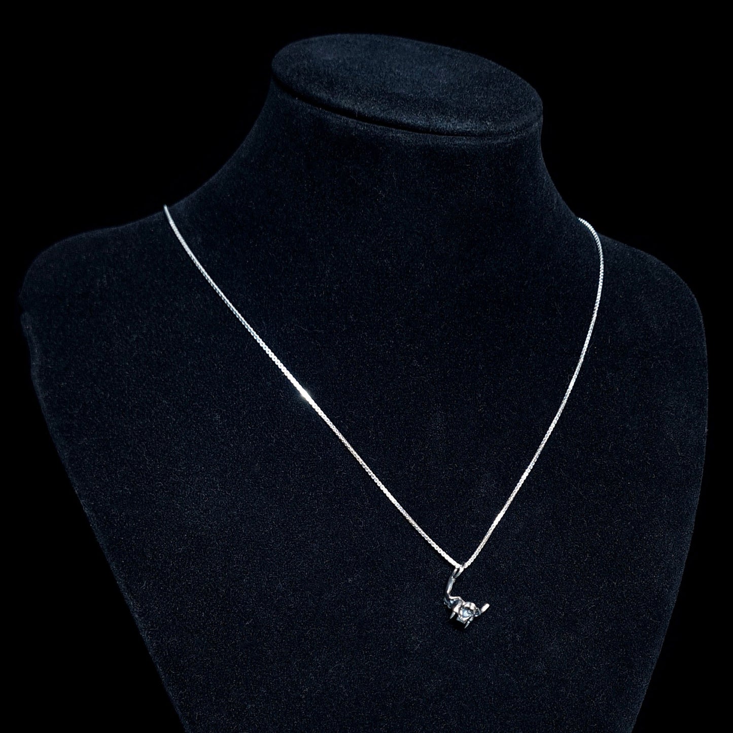 RBZ Jewelry Sterling silver Gothic Cat Skull Jawbone pendant on a silver chain, displayed on a black jewelry mannequin bust to show the pendant's hang and scale.