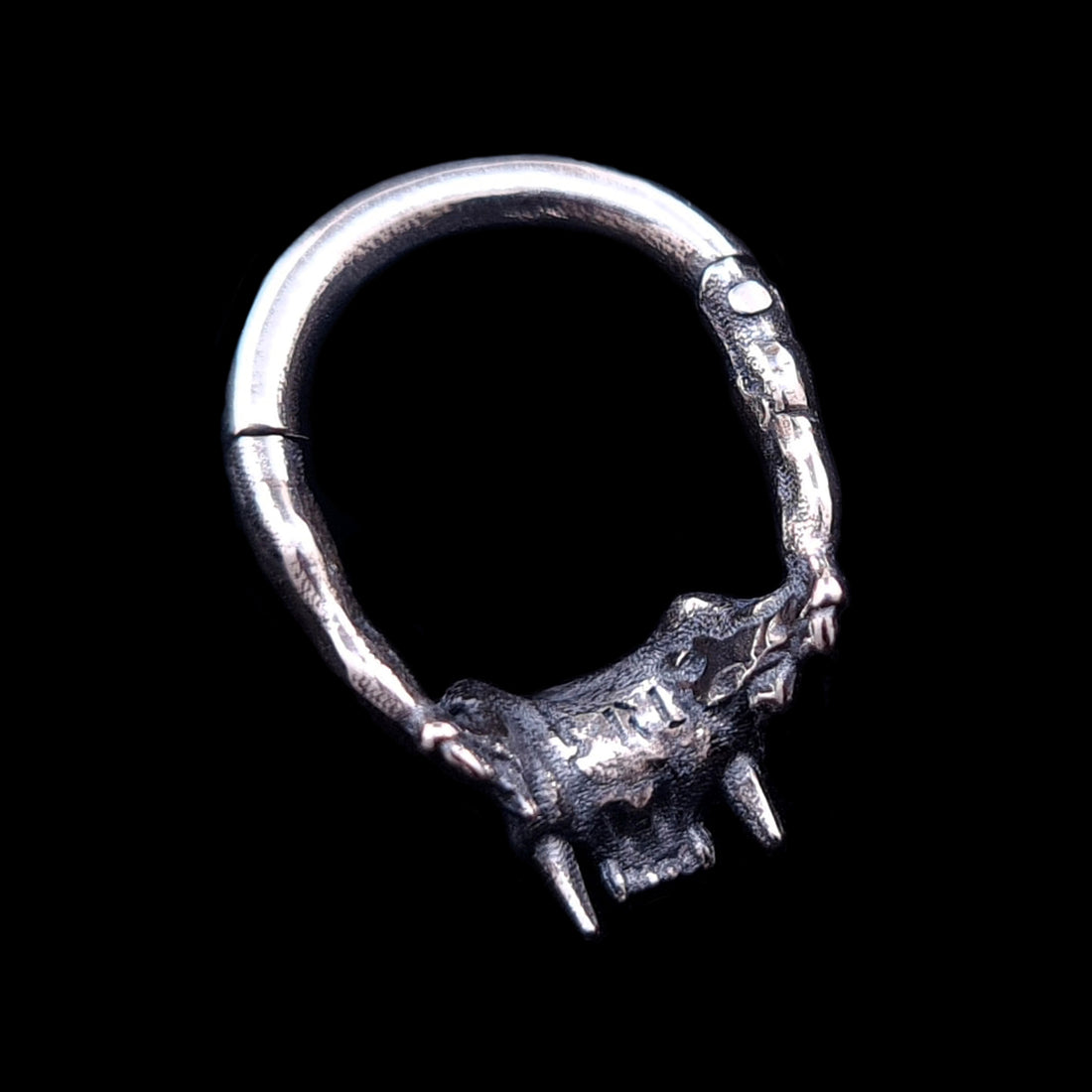 Back view of the RBZ Jewelry sterling silver Cat Skull septum ring, detailing the textured anatomical skull texture, fangs, clicker hinge mechanism, and the 'RBZ' logo engraving from behind, on a black background.