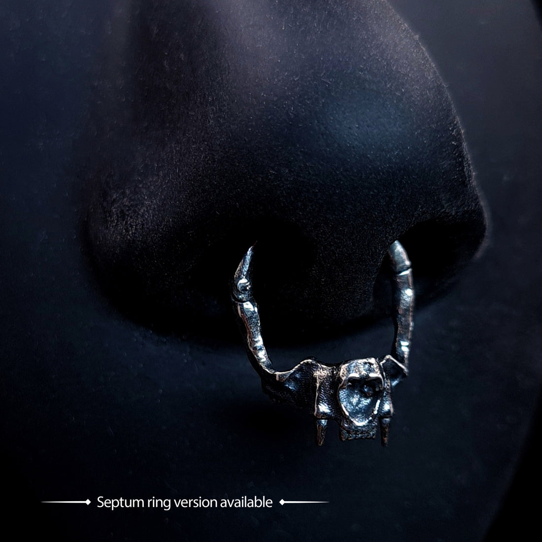 RBZ Jewelry Sterling silver Gothic Cat Skull Jawbone clicker septum ring featuring anatomical feline fangs, shown worn on a black nose model with the text "Septum ring version available."