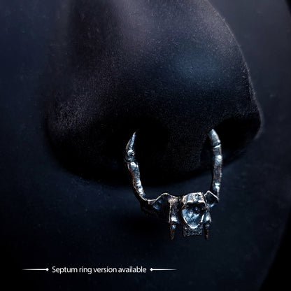 RBZ Jewelry Sterling silver Gothic Cat Skull Jawbone clicker septum ring featuring anatomical feline fangs, shown worn on a black nose model with the text "Septum ring version available."