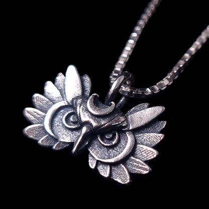 Oxidized sterling silver Gothic Moon Owl pendant by RBZ Jewelry featuring a detailed owl face with a crescent moon crown and intricate textured plumage, displayed on a silver box chain against a black background.