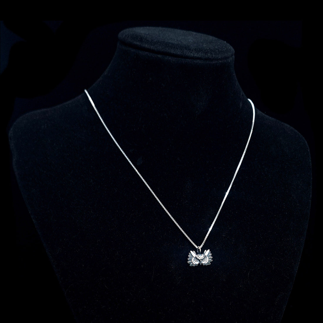 Oxidized sterling silver Gothic Moon Owl pendant by RBZ Jewelry, featuring a crescent moon crown and detailed plumage, worn on a silver chain and displayed on a black mannequin bust against a dark background.