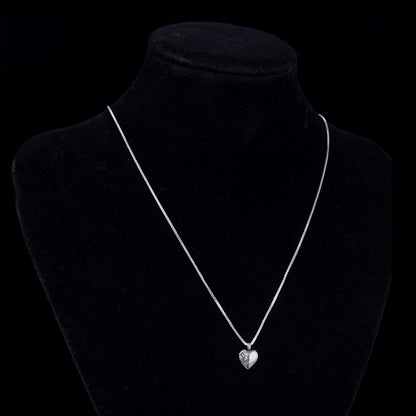 Sterling silver Ribcage Heart pendant by RBZ Jewelry displayed on a black mannequin bust, showing the anatomical gothic necklace's scale on a silver box chain.