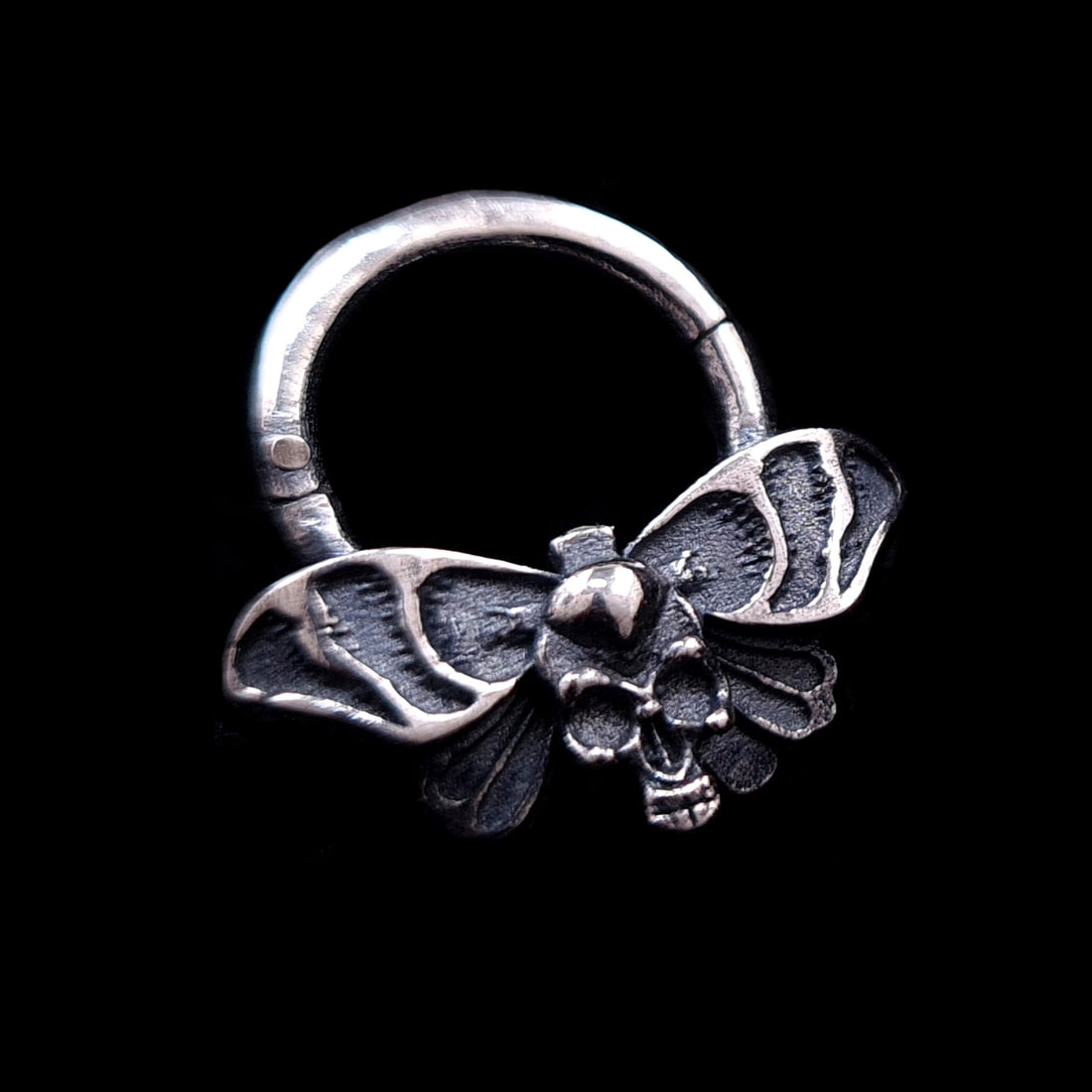 Sterling silver Gothic Death Moth septum clicker jewelry featuring an intricate skull motif on the thorax and detailed spread wings against a black background, made by RBZ jewelry.