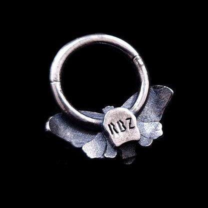 Rear view of the sterling silver Death Moth septum clicker featuring the RBZ brand engraving on the back of the moth body and a textured finish on the wings.