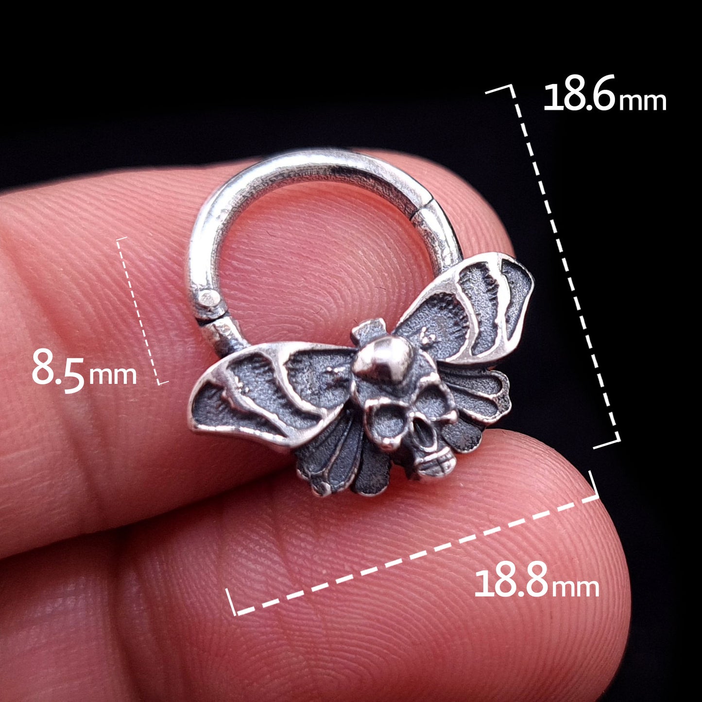 Sterling silver Gothic Death Moth septum ring held in hand, with dimension labels showing an 8.5mm inner drop, 18.6mm total height, and 18.8mm total width, made by RBZ Jewelry.