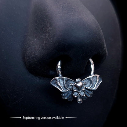 Gothic Death Moth skull septum piercing ring, sterling silver, shown modeled on a practice nose. Bottom text reads: '➡ Septum ring version available ➡' by RBZ Jewelry