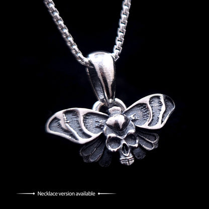 Sterling silver Gothic Death Moth pendant necklace, by RBZ Jewelry, featuring an intricate skull motif on the thorax and detailed spread wings, suspended from a silver chain against a black background.