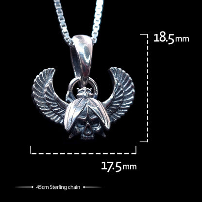 Front view of the sterling silver Gothic Egyptian Skull Scarab pendant by RBZ Jewelry, displaying dimensions of 18.5mm in height and 17.5mm in width. The pendant, featuring a detailed skull centered within outstretched feathered wings, is shown on a 45cm sterling silver chain against a black background.
