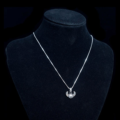 Sterling silver Gothic Egyptian Skull Scarab pendant by RBZ Jewelry, displayed on a black velvet mannequin bust to show the pendant's scale and how it hangs on a silver chain.