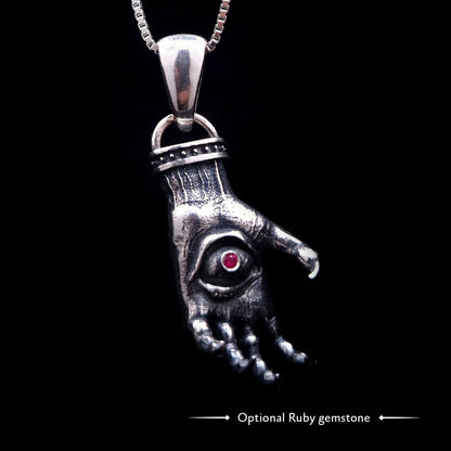 'The Nocturnal Hamsa' Sterling Silver Pendant by RBZ Jewelry - Gothic Hamsa with a creepy clawed hand design, featuring a pentagram ring and a central haunted eye with an optional ruby gemstone. The heavily oxidized silver piece hangs on a chain.