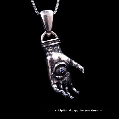 'The Nocturnal Hamsa' Sterling Silver Pendant by RBZ Jewelry - Gothic clawed hand design with a central haunted eye featuring an optional blue sapphire gemstone, hanging from a silver chain.