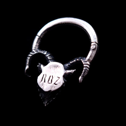 Back view of the sterling silver Horned Demon septum clicker ring by RBZ Jewelry, showing the hinge mechanism and a smooth backplate engraved with the letters RBZ, set against a solid black background.