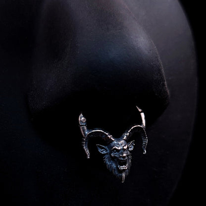 Sterling silver Horned Demon septum ring by RBZ Jewelry worn on a life-size black silicone nose, demonstrating the fit and prominent placement of the detailed, oxidized gothic demon face and textured horns against a dark background.