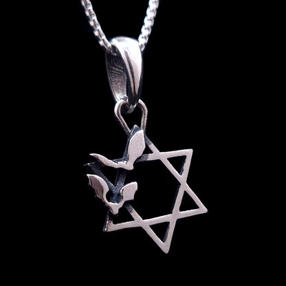 Sterling silver Star of David pendant with two bats flying across the Magen David, featuring an oxidized Gothic Judaica design by RBZ Jewelry, shown hanging from a silver chain against a black background.