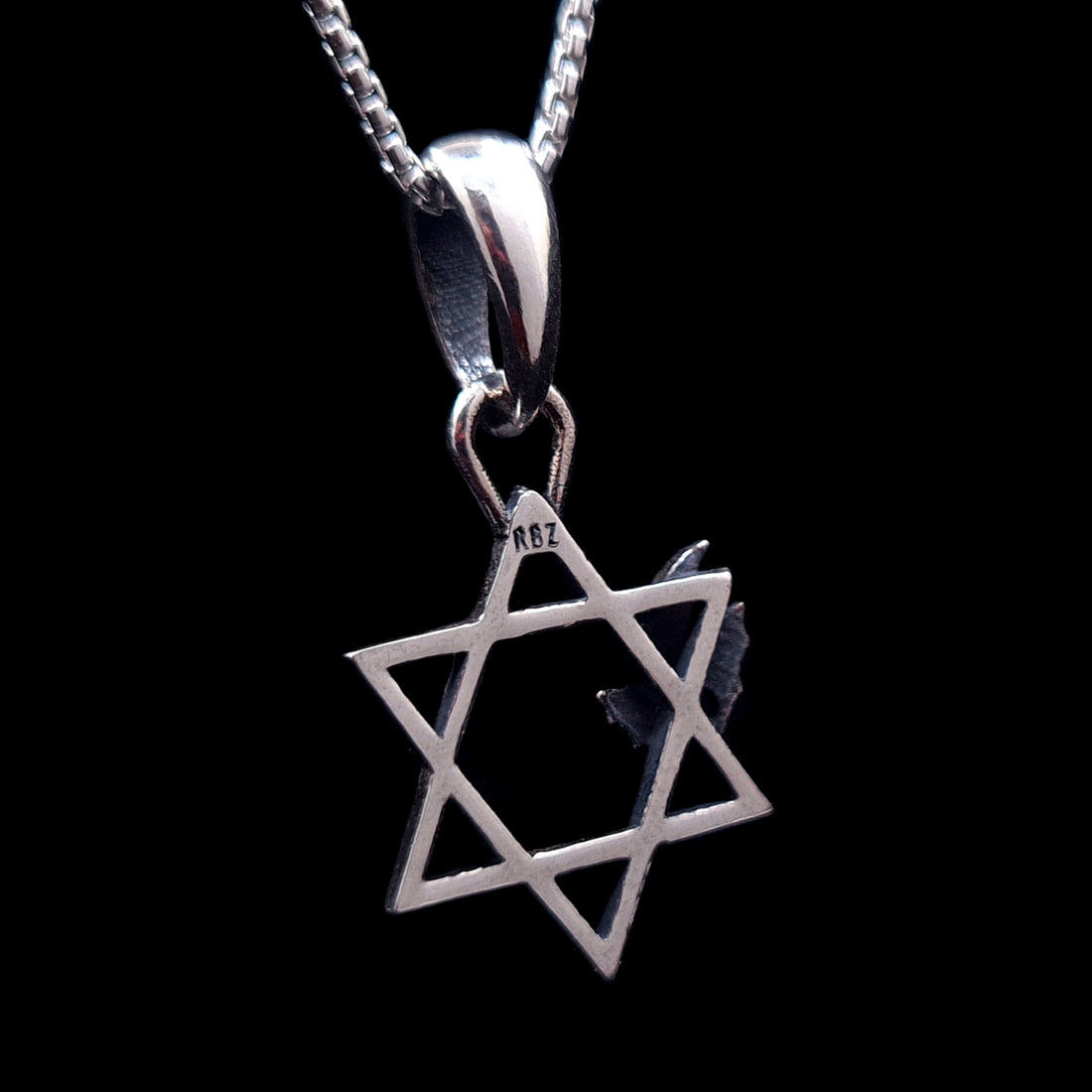 Back view of the sterling silver Bats Star of David pendant by RBZ Jewelry, showing the RBZ designer hallmark stamped on the top point of the Magen David, isolated on a black background.