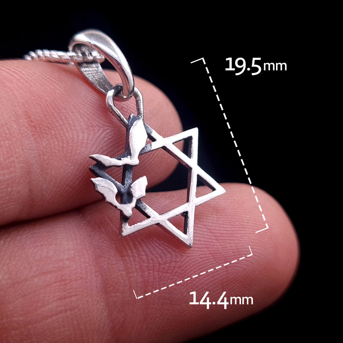 Sterling silver Bats Star of David pendant held between fingers to show scale, with dimension overlays indicating a height of 19.5mm and a width of 14.4mm, designed by RBZ Jewelry.