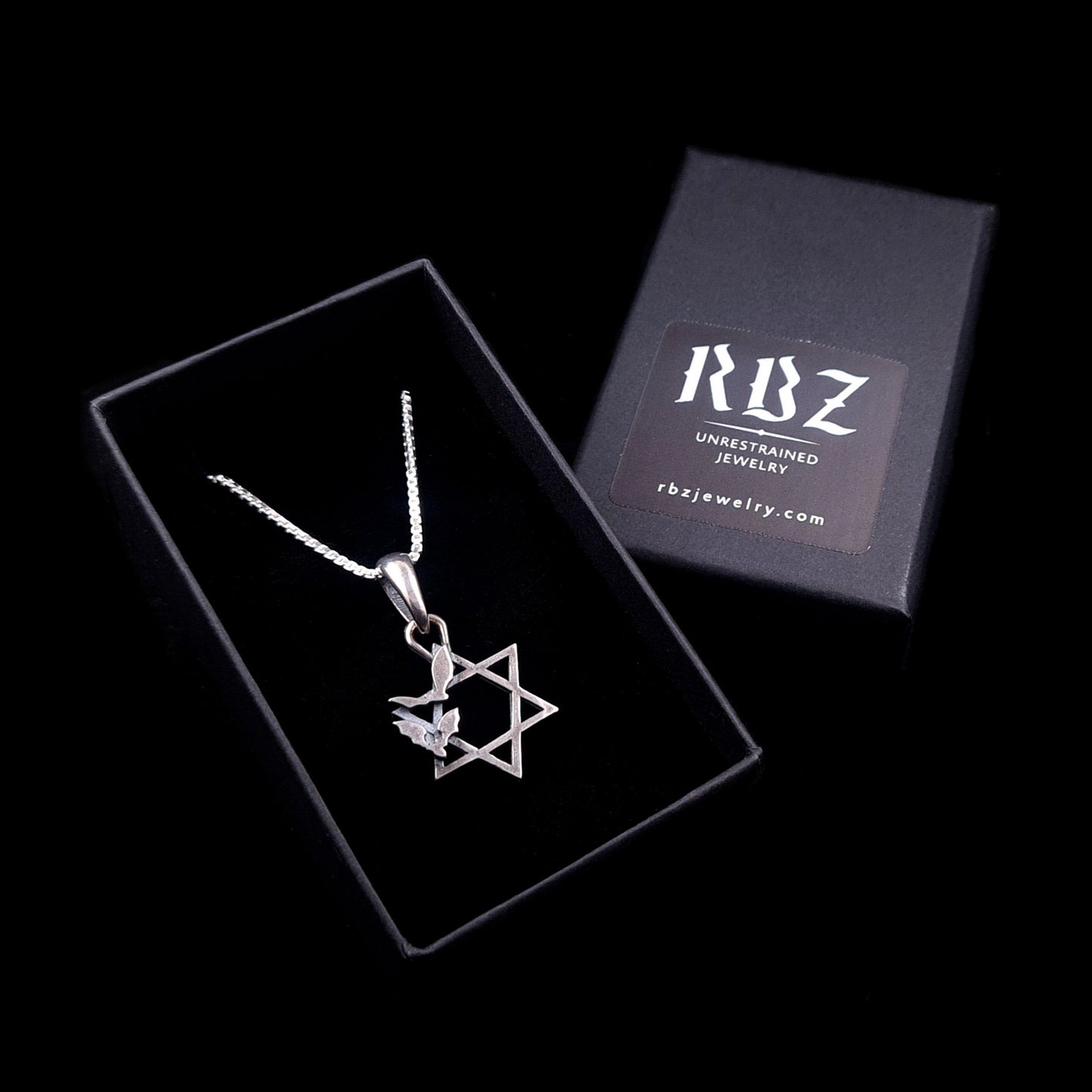 Sterling silver Bats Star of David pendant presented inside an open black RBZ Jewelry gift box, with the branded lid showing the RBZ Unrestrained Jewelry logo and website URL against a black background.