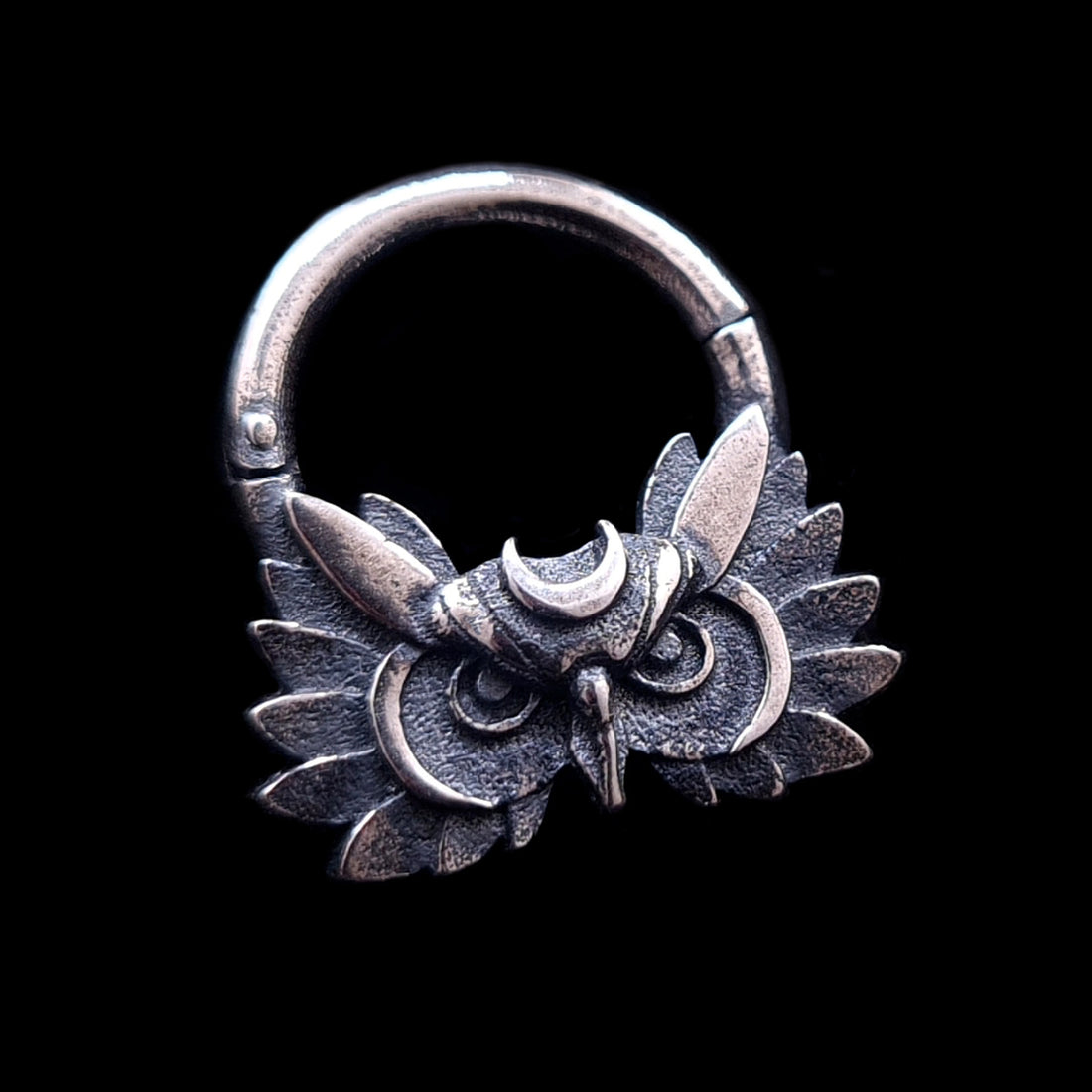 Sterling silver Moon Owl septum ring by RBZ Jewelry, featuring a handcrafted, detailed owl face with a silver crescent moon on the forehead and textured wings. The gothic-style septum clicker has a weathered, dark oxidized finish and is centered against a solid black background.