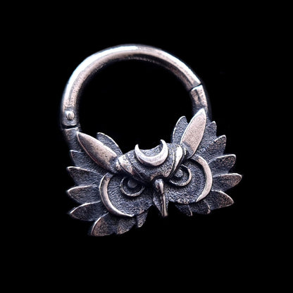 Sterling silver Moon Owl septum ring by RBZ Jewelry, featuring a handcrafted, detailed owl face with a silver crescent moon on the forehead and textured wings. The gothic-style septum clicker has a weathered, dark oxidized finish and is centered against a solid black background.