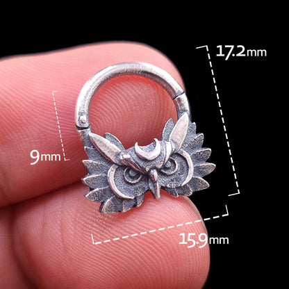 Handheld front view of the Sterling silver Moon Owl septum ring by RBZ Jewelry, showcasing the intricate owl design and crescent moon crown. The image includes scale markers indicating dimensions of 9mm inner drop, 15.9mm width, and 17.2mm total height, held against a black background.