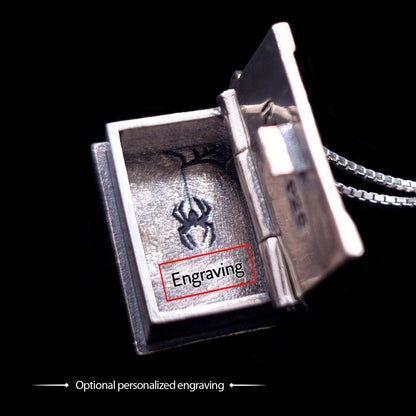 Open view of the sterling silver Necronomicon book locket pendant, highlighting the customization options. The hollow interior features the secret spider engraving and a red box labeled "Engraving" to indicate the location for optional personalized text. The image showcases the polished silver walls, the functional hinge, and the silver box chain against a black background, emphasizing the high-quality nature of this RBZ Jewelry gothic horror piece.