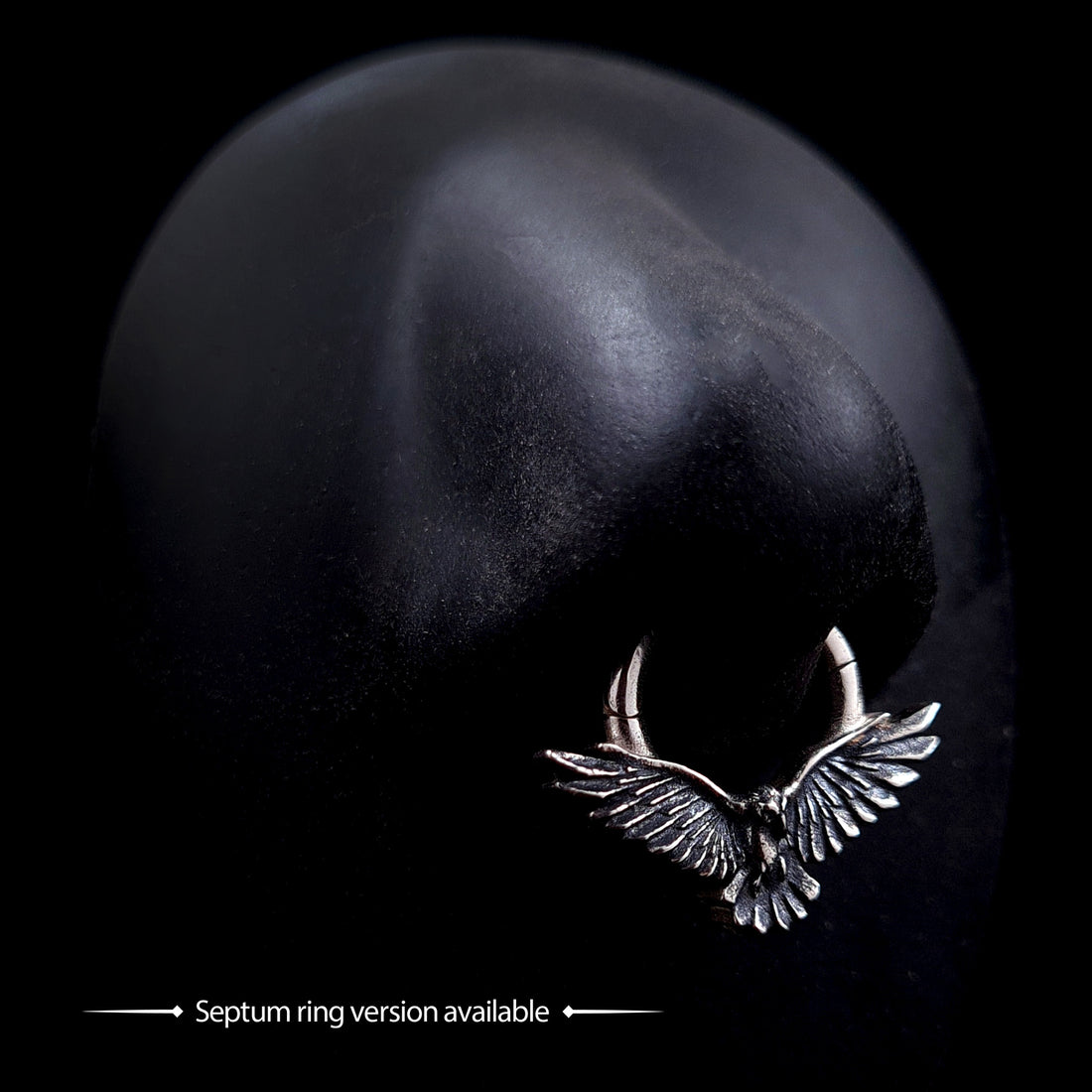 Sterling silver flying raven clicker septum ring with detailed textured wings, shown on a mannequin nose to display the Gothic style crow body jewelry by RBZ Jewelry.