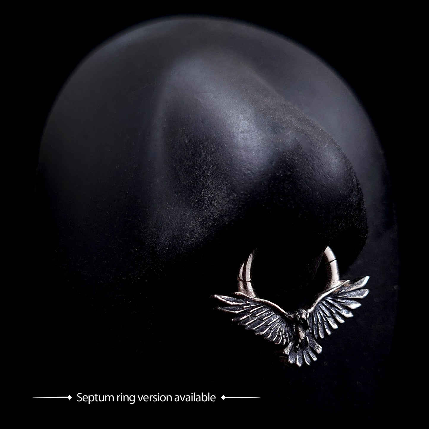 Sterling silver flying raven clicker septum ring with detailed textured wings, shown on a mannequin nose to display the Gothic style crow body jewelry by RBZ Jewelry.