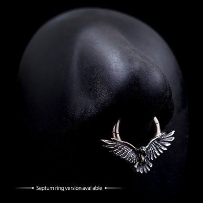 Sterling silver flying raven clicker septum ring with detailed textured wings, shown on a mannequin nose to display the Gothic style crow body jewelry by RBZ Jewelry.