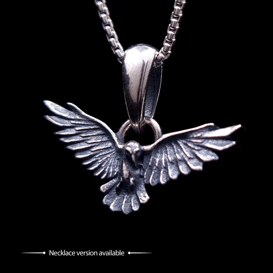 Sterling silver Dark Raven pendant by RBZ Jewelry, showcasing the detailed bird in flight with outspread wings and an oxidized finish, hanging from a silver chain to demonstrate the necklace version of the design.