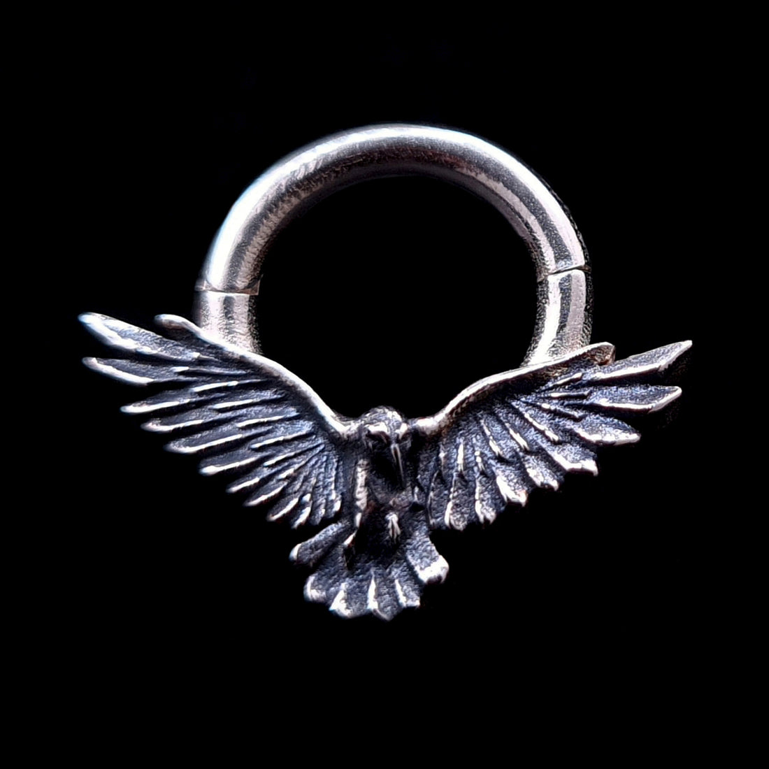 Sterling silver Dark Raven septum ring by RBZ Jewelry, featuring a detailed raven in mid-flight with wide outspread wings and an oxidized antique finish on a solid black background.