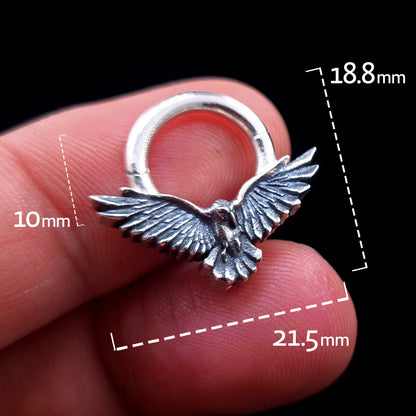 Sterling silver Dark Raven septum ring by RBZ Jewelry held between fingers, featuring dimension overlays indicating a 21.5mm wingspan width, 18.8mm total height, and a 10mm inner drop.
