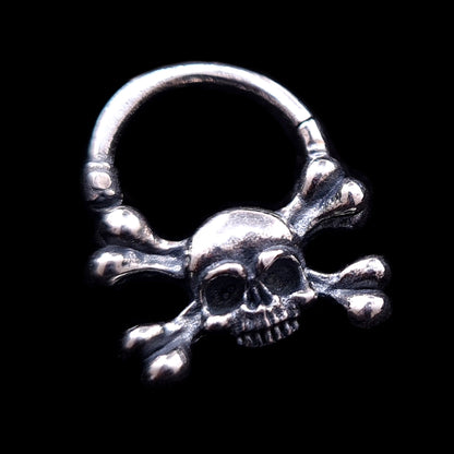 Hand-crafted Gothic sterling silver skull and crossbones septum clicker by RBZ Jewelry, featuring a weathered, oxidized finish and detailed memento mori design against a solid black background.