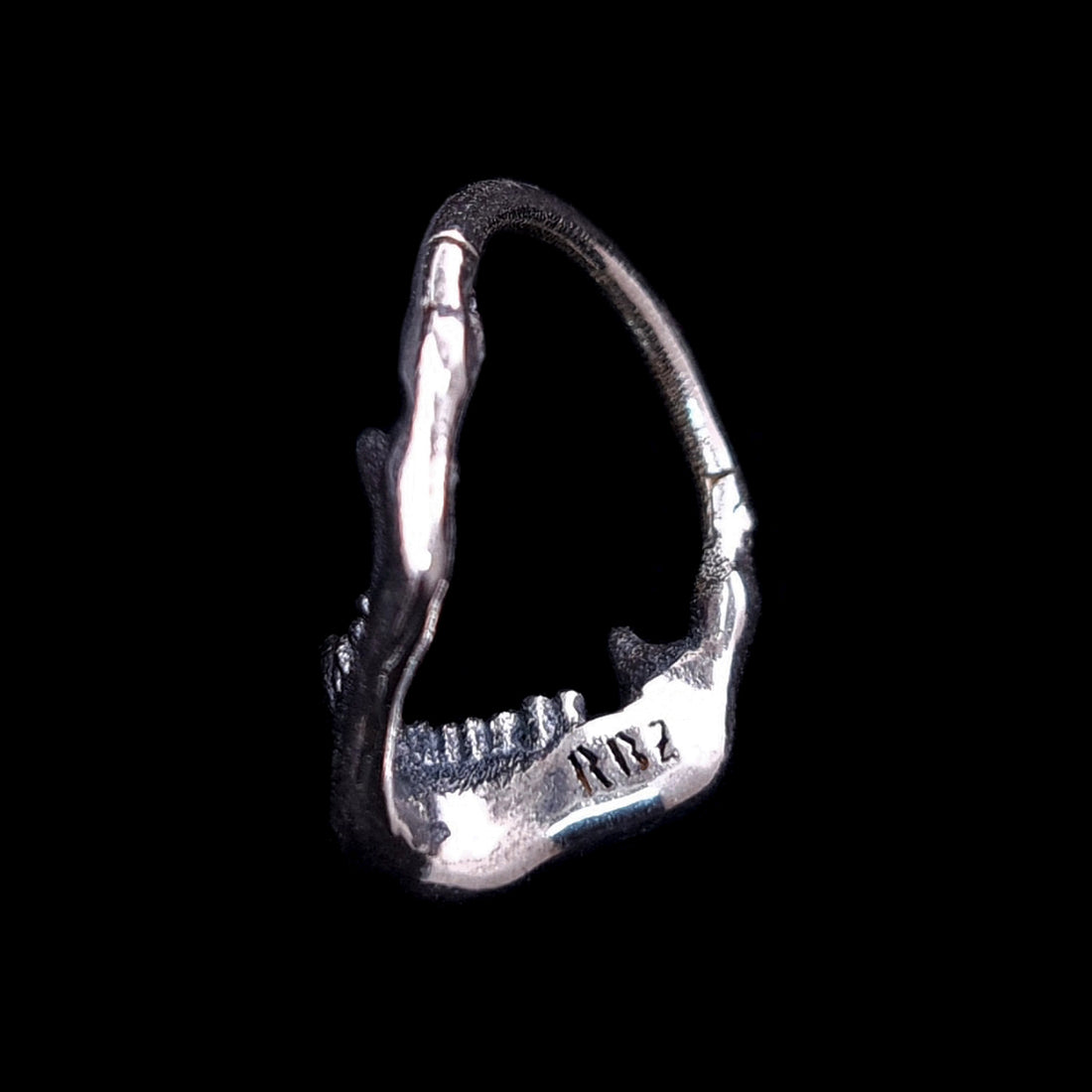 Back view of the Sterling silver Reaped Mandible clicker septum ring by RBZ Jewelry, showcasing the handcrafted interior with the signature RBZ logo engraving on the oxidized gothic skull jaw design.